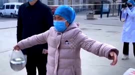 Chinese nurse gives daughter 'air hug' during Wuhan's 2020 lockdown