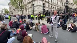 Anti-vaxers protest Boris Johnson outside Downing Street as British PM makes statement on partygate