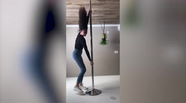 Canadian pole performer holds herself upside down and dances on the ceiling