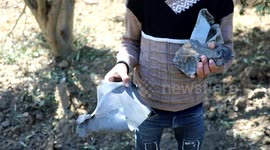 Palestinians inspect land hit by Israeli attack in Gaza Strip's Bureij refugee camp