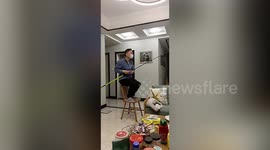 Man in China fish in fish tank at home during lockdown