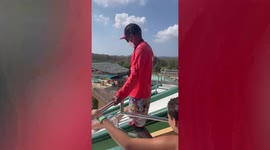 Tourist does impressive double flip rotation dive on waterpark slide