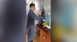 Man in quarantine seal up his home with plastic film, leaving small hole to do Covid test in China