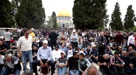 Palestinians perform Friday prayers, the third of the Muslim holy month of Ramadan, at Jerusalem's Al-Aqsa Mosque complex