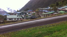 Lukla airport, close shot of airplane landing and helicopter take off