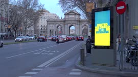 Illuminated sign in blue and yellow in support of Ukraine near Madrid's Puerta de Alcala landmark