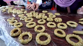 Volunteers in Gaza make traditional date-filled cakes for needy families, ahead of Eid al Fitr