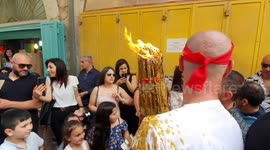 Bagpipes and holy fire as worshipers light candles in the courtyard of Jerusalem's Holy Sepulchre church