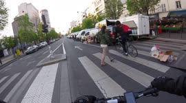 Near-miss (near accident) on the streets of Paris as a cylist cuts dangerously the road to a pedestrian. Avenue d'Italie. 24 april 2022