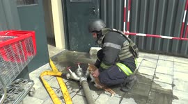 A firefighter in Kharkiv, Ukraine, washes a cat rescued from rubble after Russian shelling