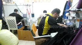 Palestinian tailors make clothes for the Eid al-Fitr festival at a sewing factory in Gaza city