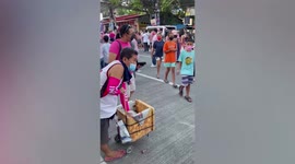 Vendor hands out free Ice lollies at street party for Philippine presidential candidate Leni Robredo