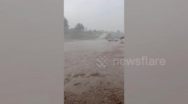 Sudden tropical storm blows away marquees next to lake in Thailand