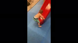 'Adventurous toddler tries to walk up a slide *HE COULDN'T MAKE IT!*'