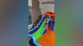 Woman overshoots inflatable water slide
