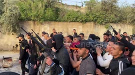 Palestinians and gun-toting men accompany body of Ahmad Massad, killed in Israeli raid in Jenin, West Bank