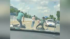 Two men stamp on each other's scooters during argument on road in China