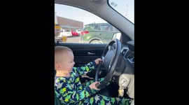 'Thoughtful toddler worries about leaving dad behind while pretending to drive '