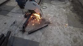 Indian labour cutting metal plate in construction work in India