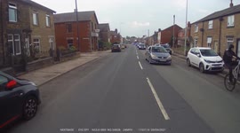 Cyclist performs Wheelie in rush hour traffic