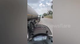 Determined policeman holds onto moving tanker's DOOR for 10 miles to catch runaway driver