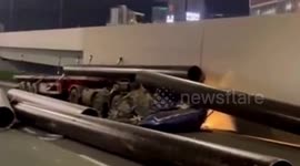 Steel pipes flatten truck cabin after vehicle performs emergency stop on road in China