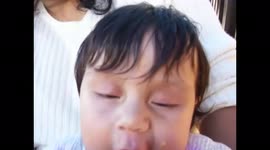 my little baby, tasting a delicious orange in mommy's arms