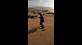 Watch this sandboarder gracefully glide down dunes in Chile's Iquique