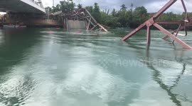 Philippines killer collapsed bridge seen this morning in fast-flowing river