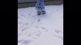A monkey in a children's costume rejoices at the first snow