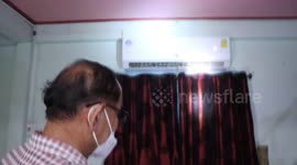 Green tree snake found 'chilling' inside home air-conditioning unit