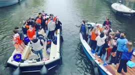 People celebrate King's Day on boats in Amsterdam, Netherlands