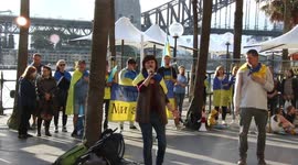 Ukrainians sing the national anthem at the end of the 'Help Ukraine Now protest' in Sydney, Australia