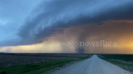 Powerful tornado forms at sunset over Kansas plains