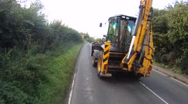 A JCB driver passes a cyclist dangerously close and too fast