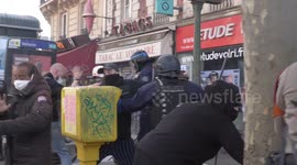 Police officer on Paris May Day protest SLAMS baton over young protester's head during demonstration