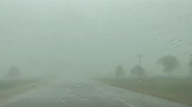 Strong winds and hail batter motorist's car as they drive through storm-hit Oklahoma