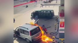 Petrol station workers scramble to extinguish flames emerging from minibus in China