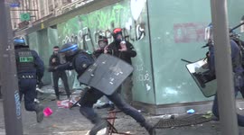 Watch moment French riot cop FALLS OVER a chair during Paris May Day clashes