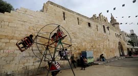Palestinian children play as they celebrate Eid al-Fitr holiday, which marks the end of the Muslim holy month of Ramadan, in Khan Younis in the southern of Gaza strip
