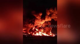 Plume of smoke shrouds sky as factory bursts into flames in China