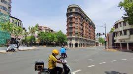 Couriers Riding In The Shanghai Street, China