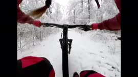 Girl rides bike very fast in winter down the hill and crashes at the end