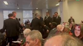 Protesters from Money Rebellion don masks of the CEO of Standard Chartered Bank and disrupt the AGM, London,England, UK