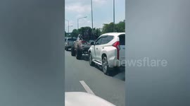 Mad Max-themed car pickup truck navigates through traffic in Thailand