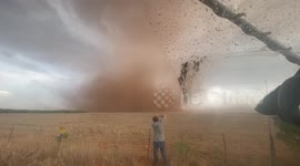 Storm-chaser gets up close to dusty tornado swirling in Texas field