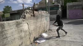 Palestinian protesters hurl stones towards Israeli forces during clashes