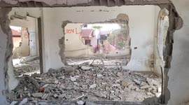Palestinians inspect the house of jailed Palestinian assailant Omar Jaradat after it was blown up by Israeli forces, in the West Bank city of Jenin