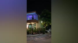 Man exercises under disco lights during lockdown in Thailand