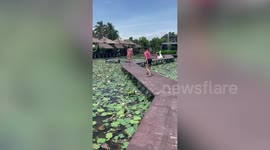 Photoshoot fail! Woman falls into water while taking video for friend